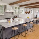 beautiful-kitchen-with-lights-off-in-new-luxury-home-with-island--pendant-lights--and-glass-fronted-cabinets--and-view-of-dining-room-676153162-00c241165e504736adfdc29edc2393bd