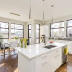 An interior shot of a modern house kitchen with large windows